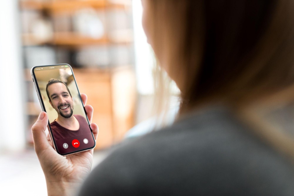 A woman enjoying a free random video chat while facetime random people online.